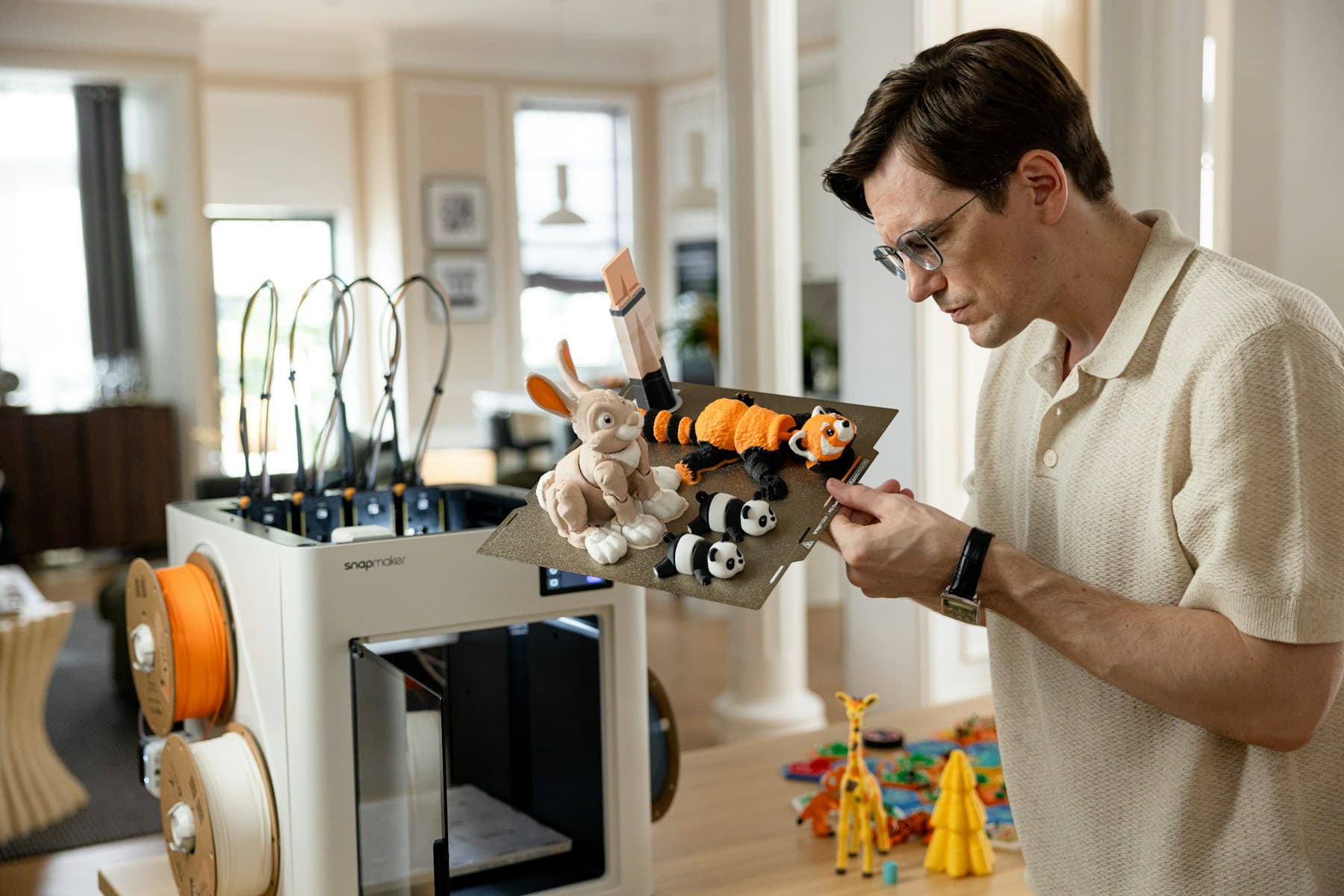 Maker removing a print from a 3D printer