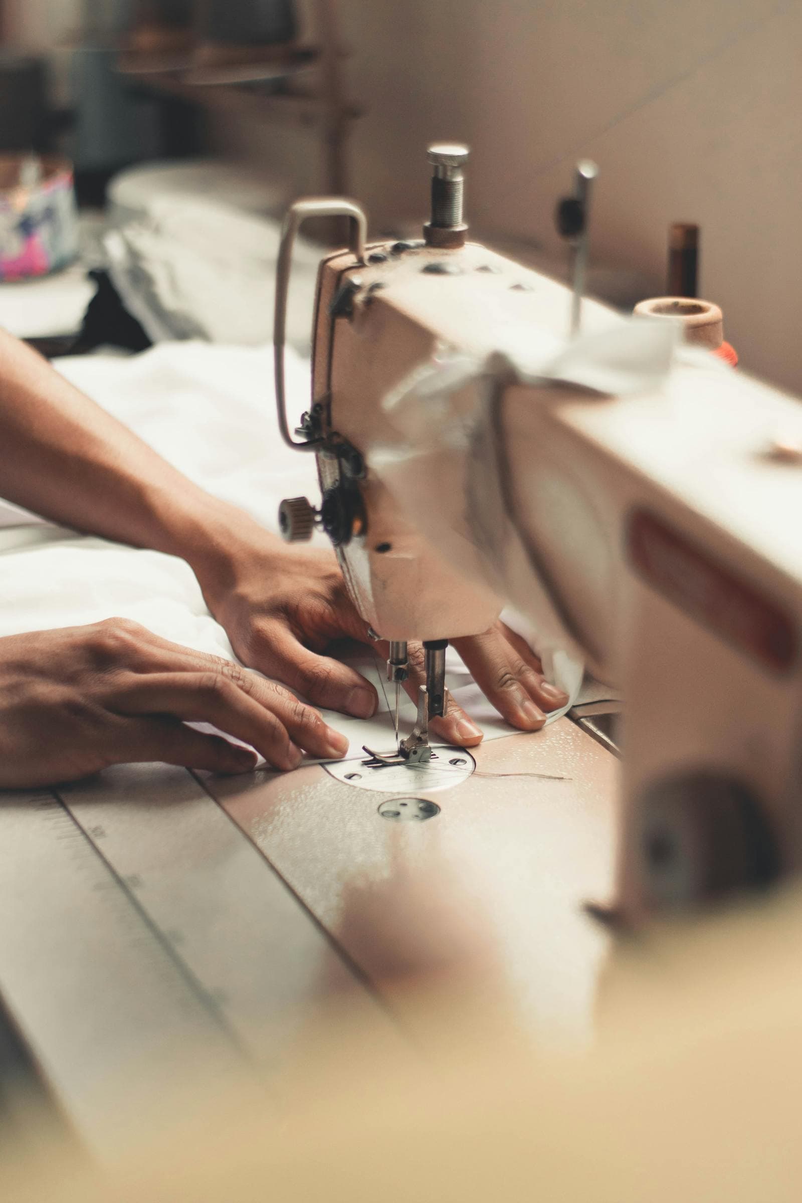 Close-up of hands sewing fabric on a machine