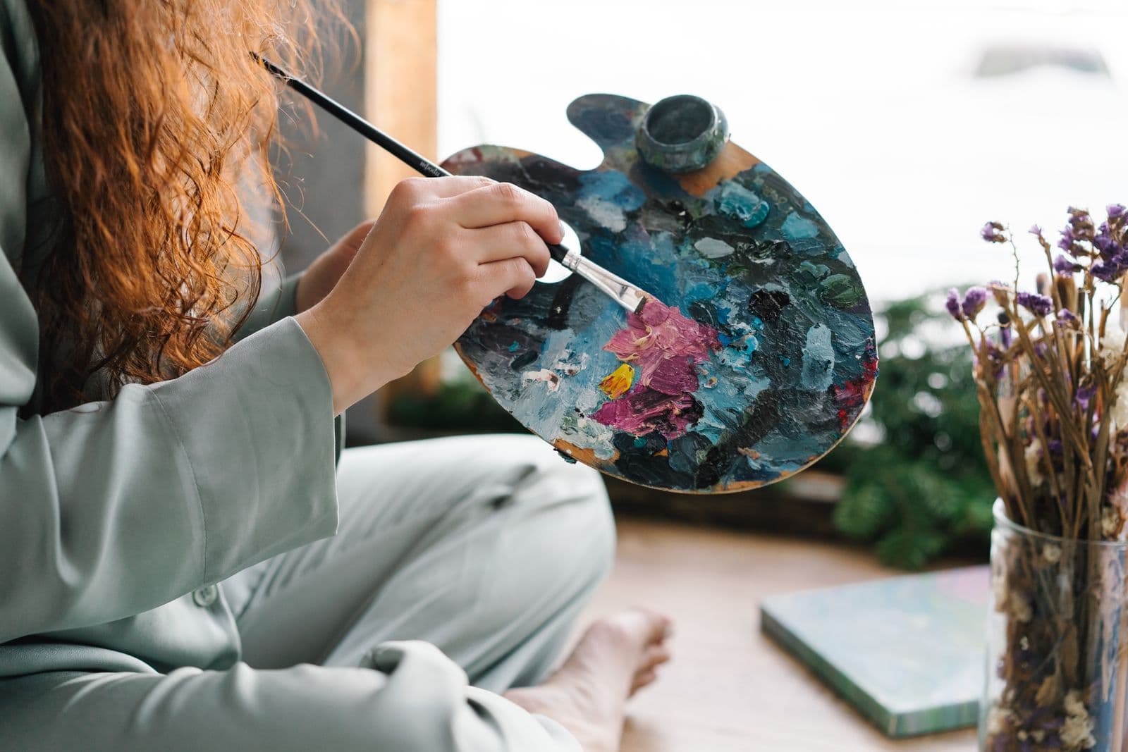 Painter holding a watercolor palette and brush