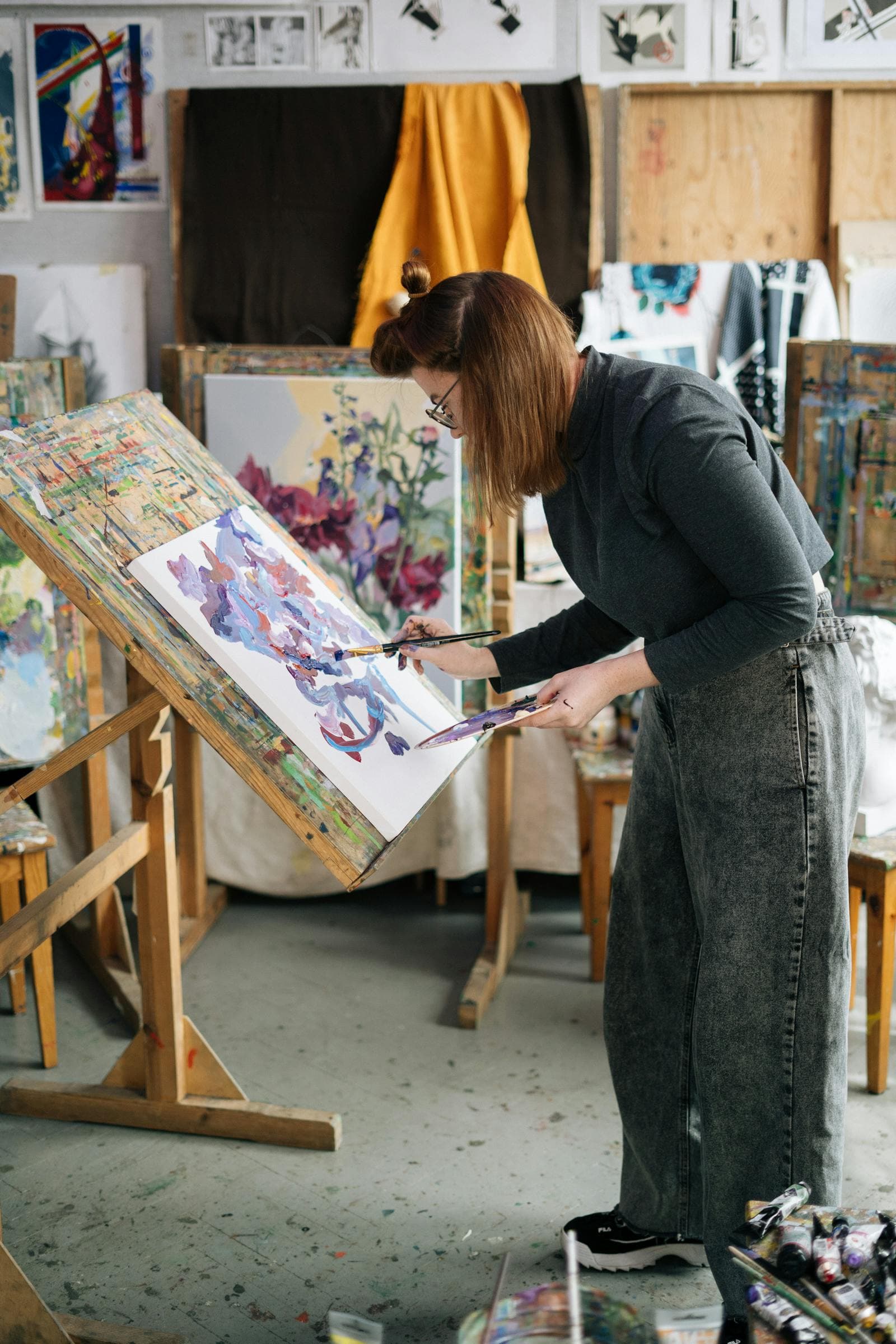 Artist painting watercolor florals on a canvas